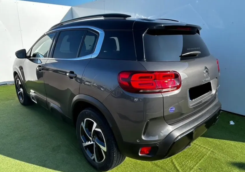 Vue 3/4 arrière droite du Citroën C5 Aircross gris platinium métallisé avec feux arrière LED et jantes alliage 18 pouces.