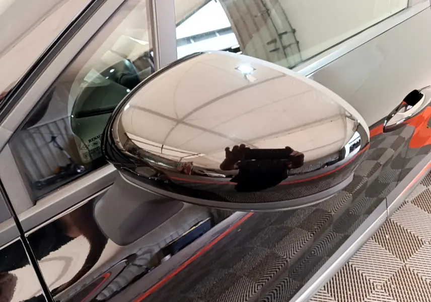 Rétroviseur côté gauche noir brillant du Renault Captur Business Blue dCi 95, reflet d'un intérieur lumineux.