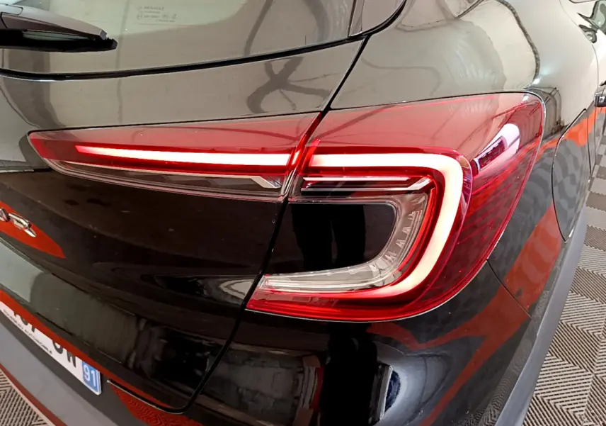 Gros plan sur le feu arrière droit rouge du Renault Captur Business noir, soulignant la finition moderne du modèle 2020.