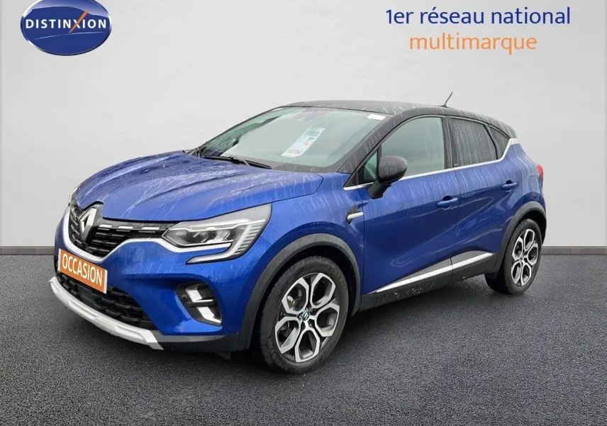 Renault Captur hybride rechargeable bleu Iron Metal avec toit noir, vue 3/4 avant droit, jantes alliage distinctives.