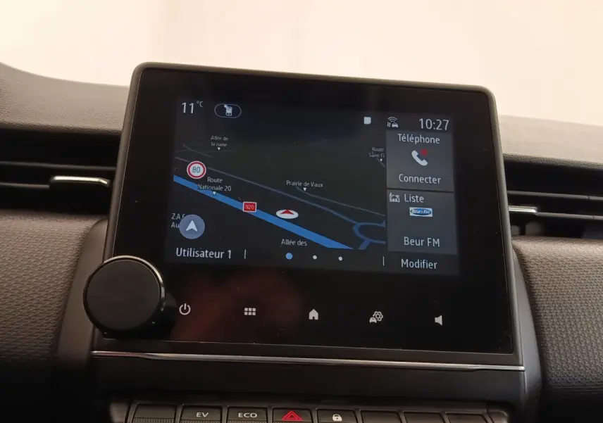 Écran tactile central de navigation et multimédia dans le tableau de bord d'une Renault Clio Business E-TECH blanc, vue intérieure.