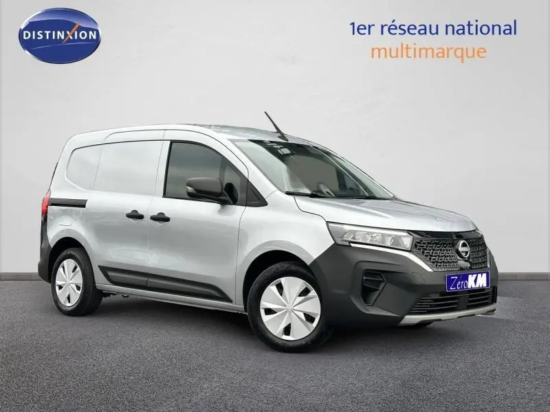 Vue 3/4 avant droite d'un Nissan Townstar gris électrique 2024 avec calandre noire et enjoliveurs blancs.