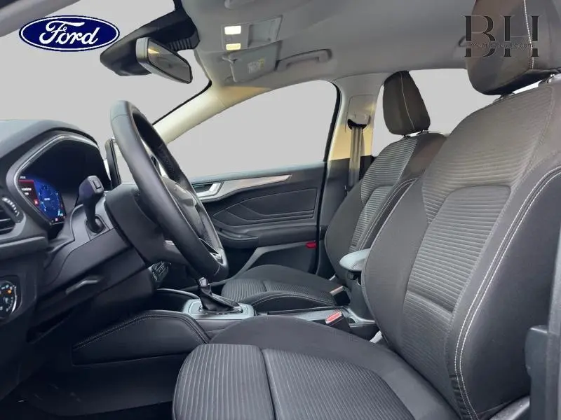 Vue intérieure côté gauche de la Ford Focus SW 2024, sièges tissu noir Ray/Eton avec volant cuir multifonction.