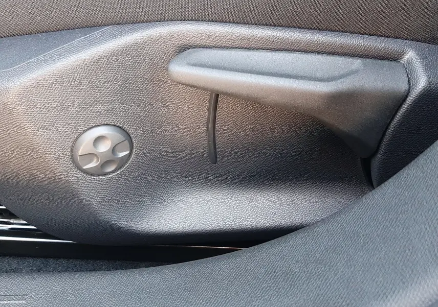 Détail des commandes de réglage manuel du siège conducteur dans une Peugeot 308 Bleu Obsession, intérieur noir.