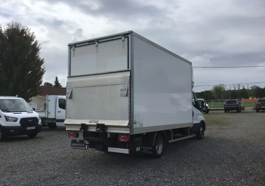 IVECO Daily Chassis Cabine blanc en 3/4 arrière droit, avec caisse 20m3 et hayon élévateur visible.