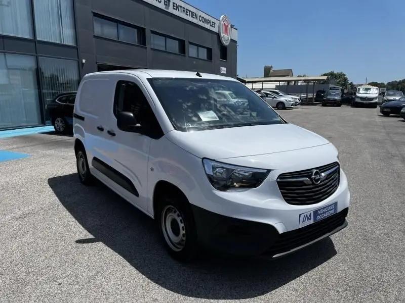 Vue 3/4 avant droite d’un Opel Combo Cargo blanc 2024, utilitaire compact avec calandre noire et rétroviseurs noirs.