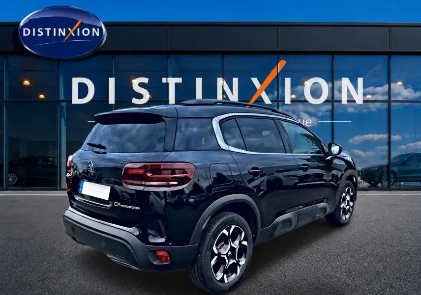 Vue 3/4 arrière droite d'un Citroën C5 Aircross noir avec jantes alu et vitres arrière teintées.