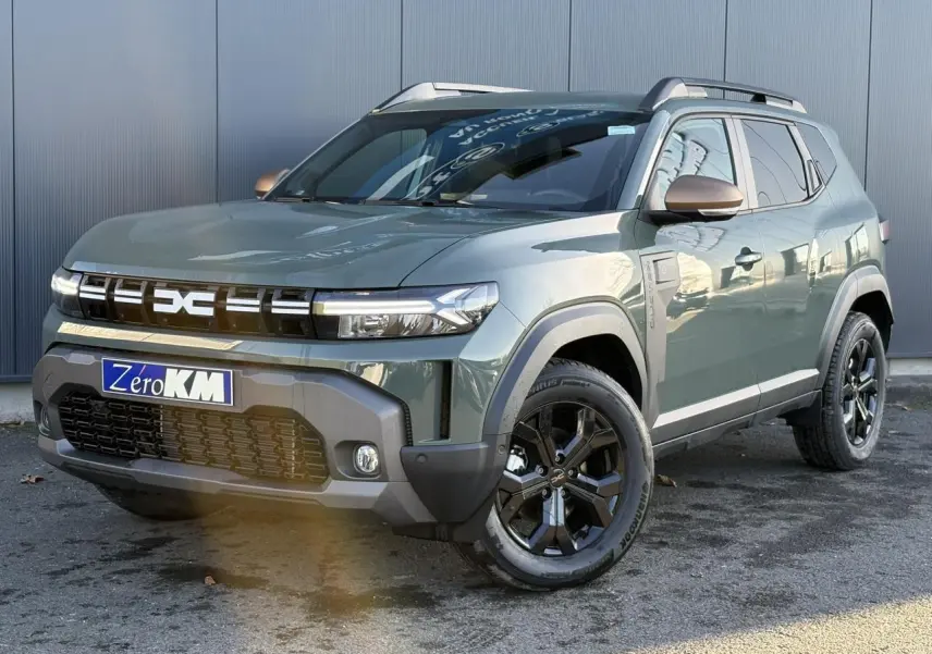 SUV Dacia Duster 2025 Kaki Lichen en 3/4 avant droit avec jantes noires et barres de toit argentées.