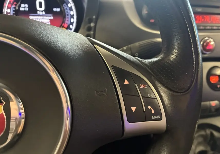 Gros plan sur le volant côté droit de l'Abarth 500 Competizione 2016, avec commandes intégrées et tableau de bord partiellement visible.