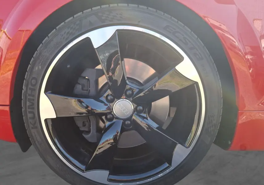 Gros plan sur la jante alliage 19” noire et argentée de l’Audi TT rouge, côté avant droit.