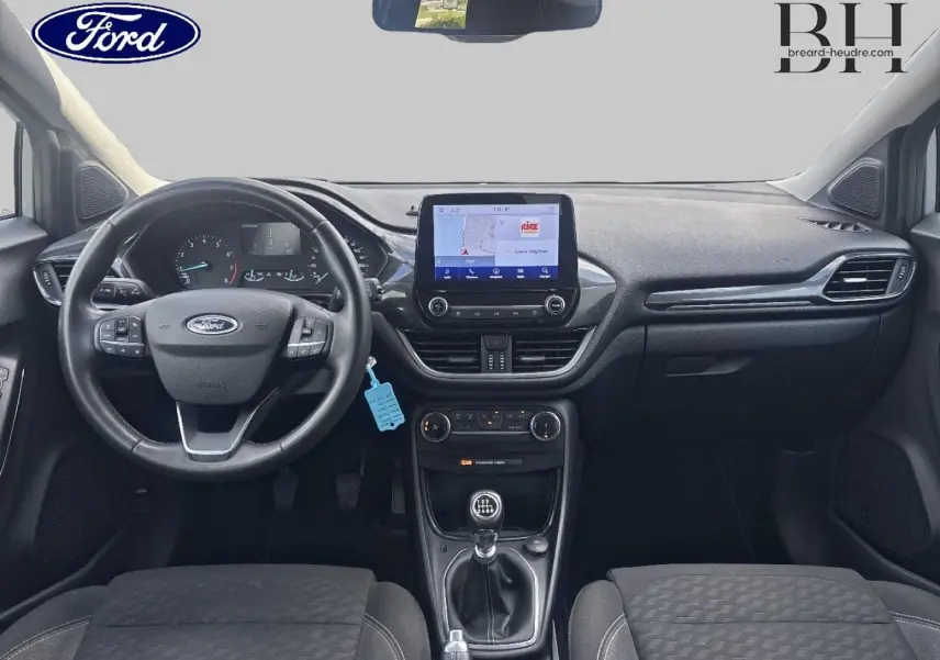 Vue intérieure avant du Ford Puma gris Solar Métallisée 2023 avec volant multifonction et écran tactile central.
