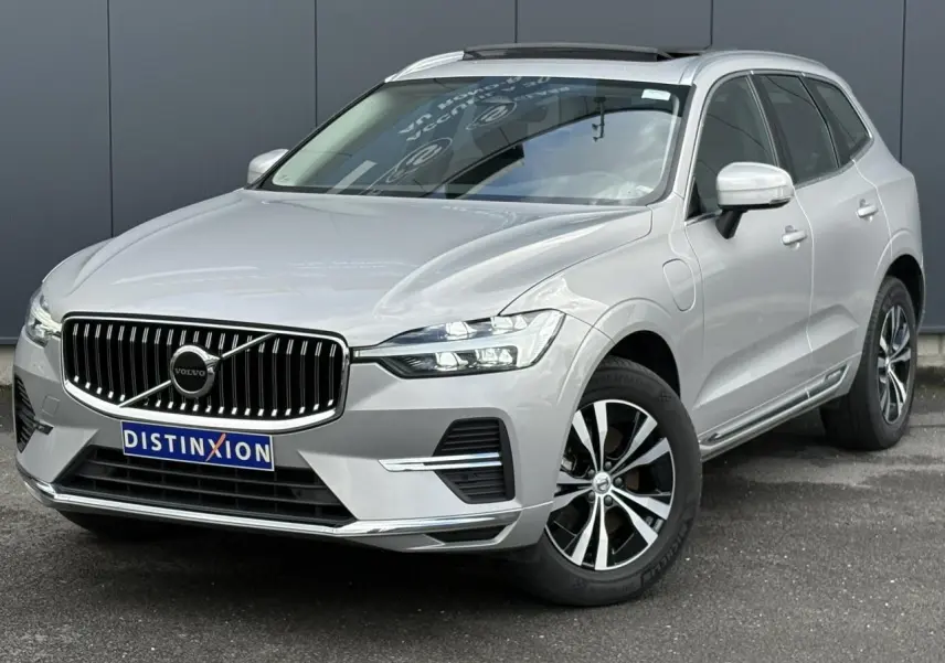 Vue 3/4 avant droit du Volvo XC60 gris silver avec calandre chromée et jantes alliage 18 pouces.