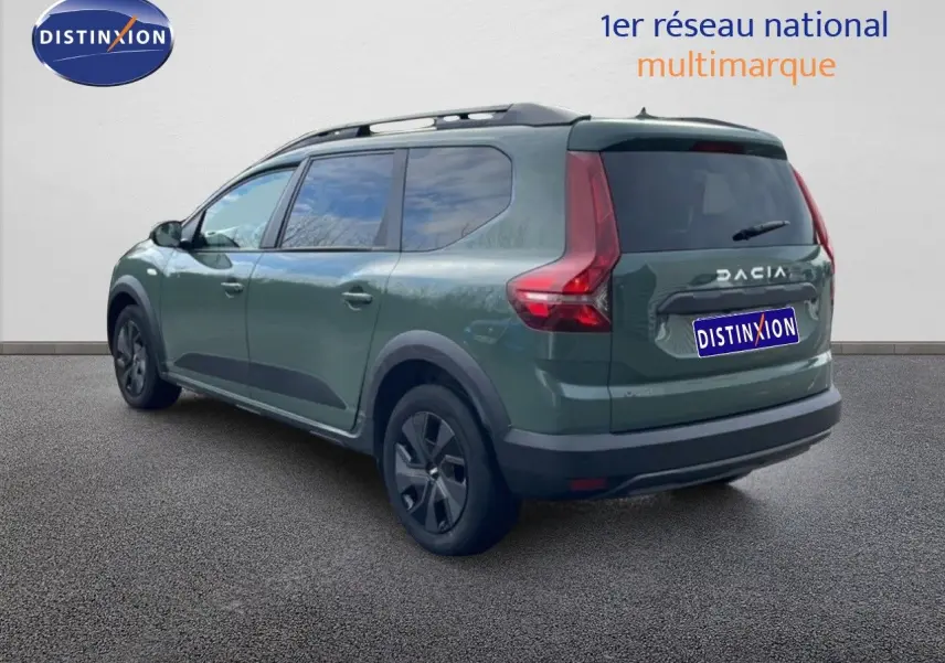 Vue 3/4 arrière droite d’un Dacia Jogger 2025 kaki lichen avec toit noir et feux arrière en forme de L.