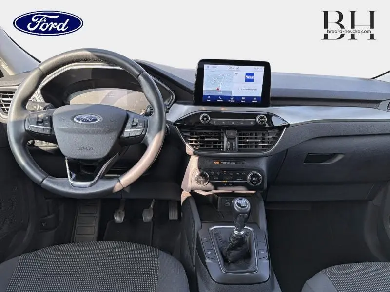 Vue intérieure avant du Ford Kuga 2.0 EcoBlue 2020, volant cuir multifonction et écran tactile central avec GPS.