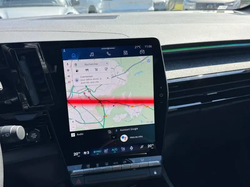 Vue rapprochée de l'écran tactile central du tableau de bord du Renault Austral blanc nacré, affichant la navigation GPS.