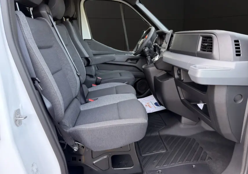 Vue intérieure côté conducteur du Renault Master blanc 2026, montrant les sièges gris et le tableau de bord moderne.