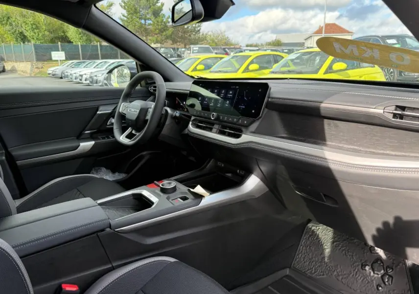 Vue intérieure côté conducteur du Jeep Compass 2026, tableau de bord moderne avec écran tactile et finitions noires et grises.