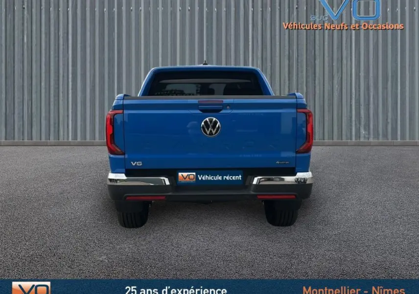 Vue arrière d'un Volkswagen Amarok Simple Cabine bleu 2025 avec logo VW et feux arrière LED distinctifs.