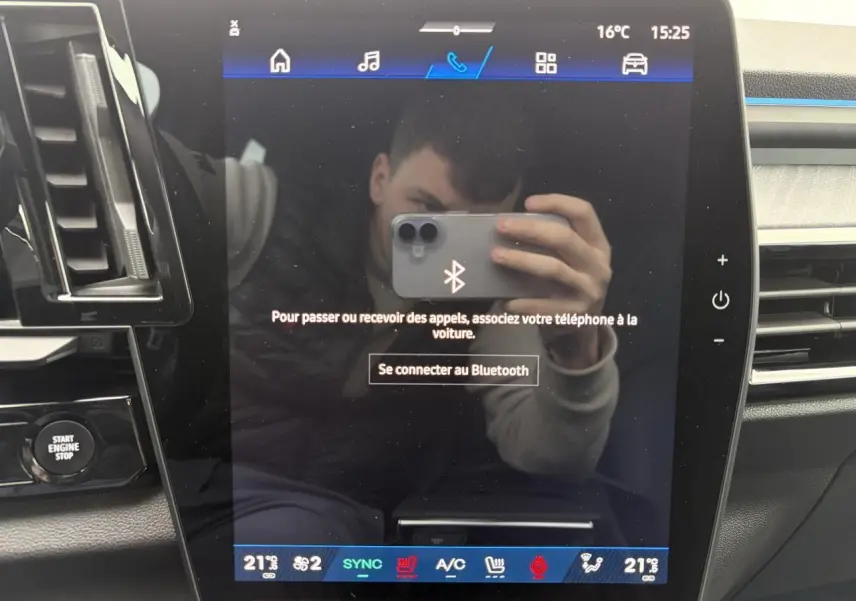 Écran tactile central du tableau de bord du Renault Rafale 2025 avec commandes climatisation et connectivité Bluetooth.