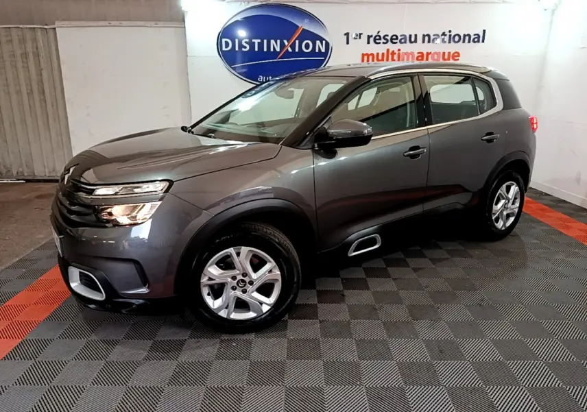Citroën C5 Aircross gris foncé vue 3/4 avant droit, avec jantes alliage 17 pouces et inserts silver anodisé visibles.