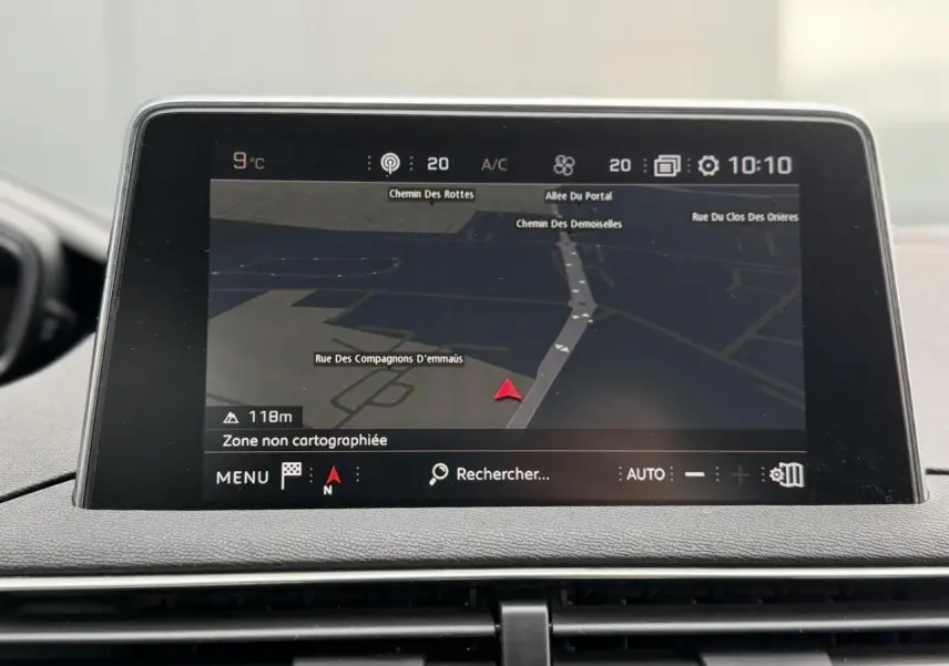 Écran tactile du système de navigation Peugeot i-Cockpit affichant une carte en intérieur du 5008 bleu foncé.
