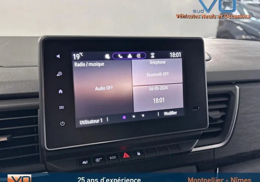 Écran tactile central du tableau de bord du Renault Trafic Fourgon gris, affichant les options audio et téléphone.
