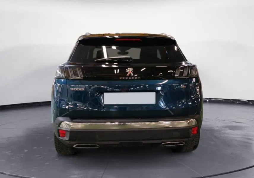 Vue arrière d'un Peugeot 3008 Hybrid 225 e-EAT8 GT Pack bleu clair avec feux noirs et double sortie d'échappement.
