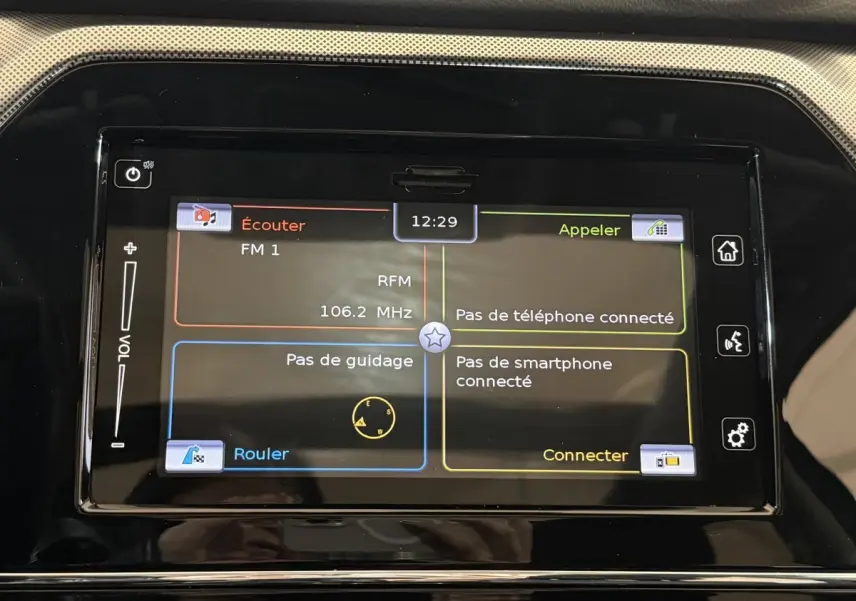 Écran tactile central du Suzuki Vitara noir 2022 affichant radio FM et options de connexion smartphone et téléphone.