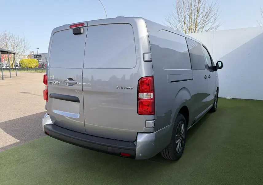 Vue 3/4 arrière droit d'un Citroën Jumpy gris acier métal avec portes arrière battantes et jantes alliage 17 pouces.