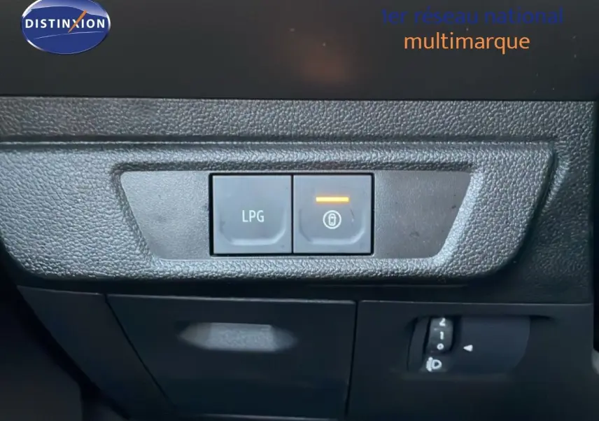 Gros plan sur les boutons de commande LPG et verrouillage intérieur du tableau de bord du Dacia Jogger gris schiste métal.