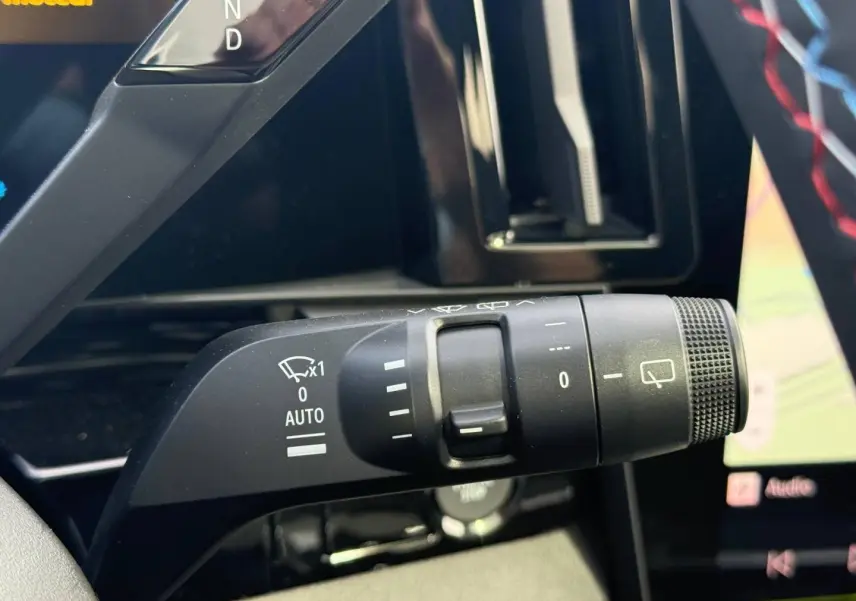 Gros plan sur la commande de l'essuie-glace du Renault Austral 2026, intérieur noir avec détails blancs.