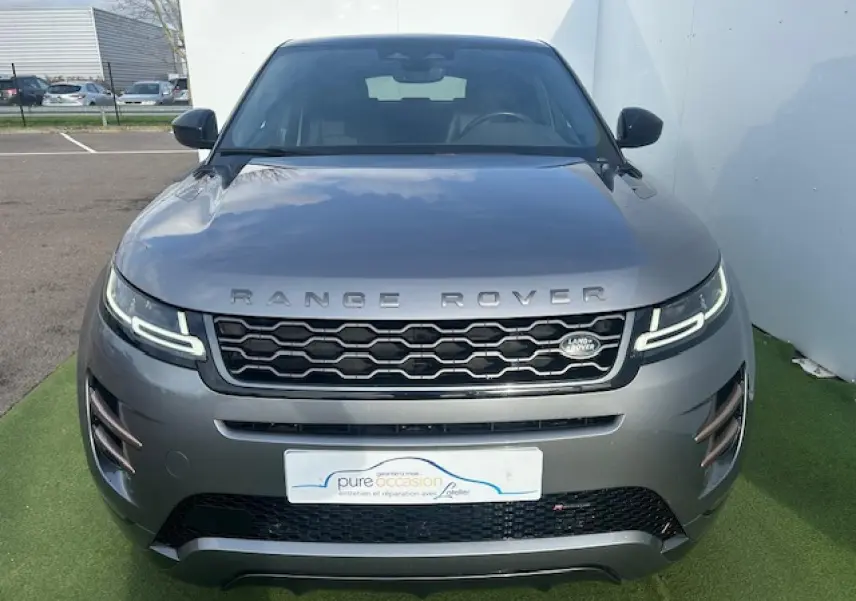 Vue avant d'un Range Rover Evoque II D200 4WD R-Dynamic SE gris foncé avec calandre hexagonale et phares LED distinctifs.