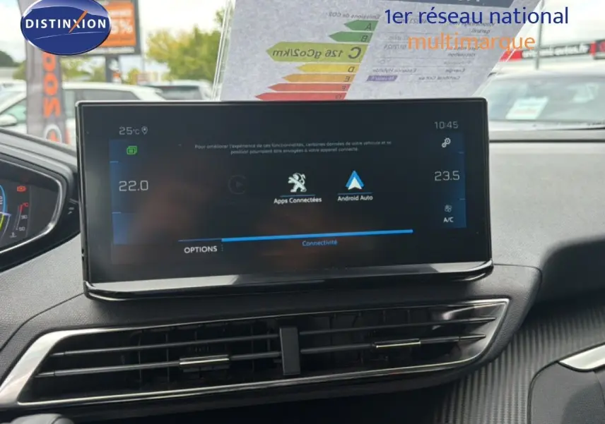 Vue intérieure du tableau de bord du Peugeot 5008 Hybrid 2024, écran tactile central affichant les applications connectées.