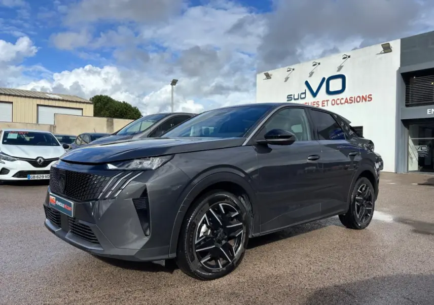 Peugeot 3008 Hybrid gris en 3/4 avant droit, avec jantes alliage noires de 19 pouces et calandre distinctive.