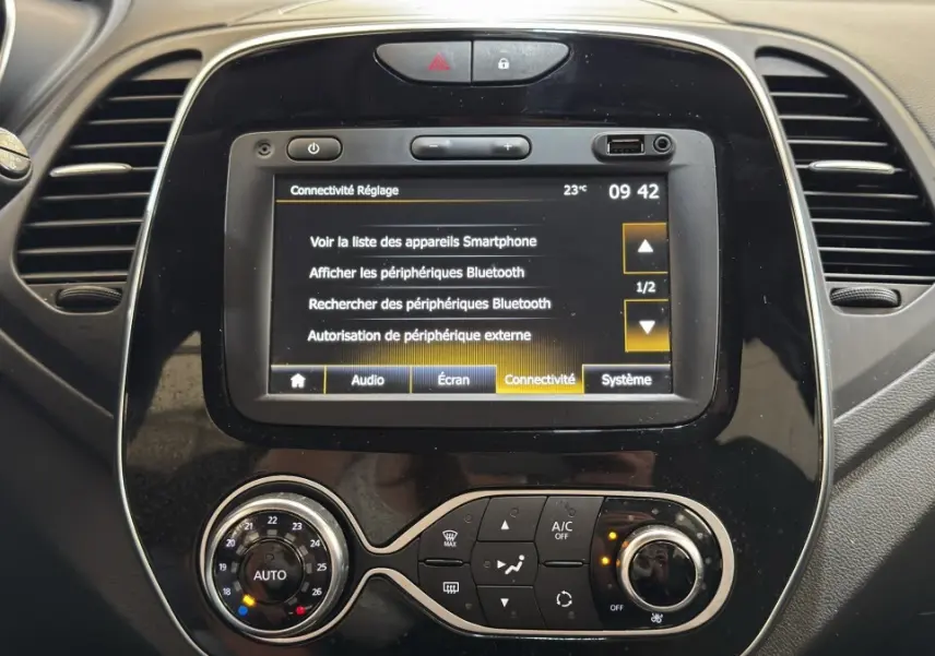 Vue rapprochée du tableau de bord noir du Renault Captur Intens TCe 90 2019, avec écran tactile affichant les réglages Bluetooth.