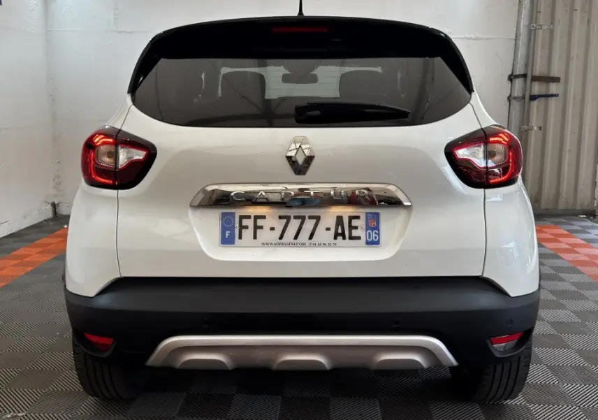 Vue arrière d'un Renault Captur blanc 2019 avec feux LED et plaque d'immatriculation française visible.