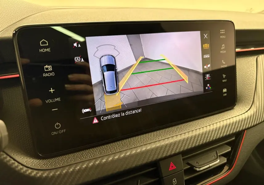 Écran tactile intérieur du Skoda Kamiq 2024 montrant la caméra de recul avec guidage de trajectoire en gris graphite.