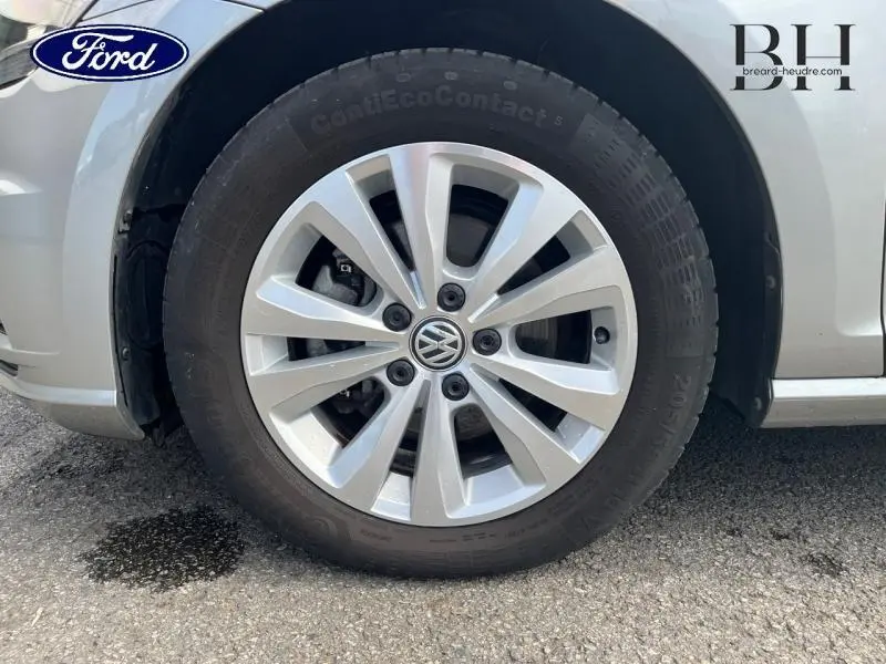 Gros plan sur la roue avant gauche d'une Volkswagen Golf SW gris Tungsten avec jante alu à dix branches.