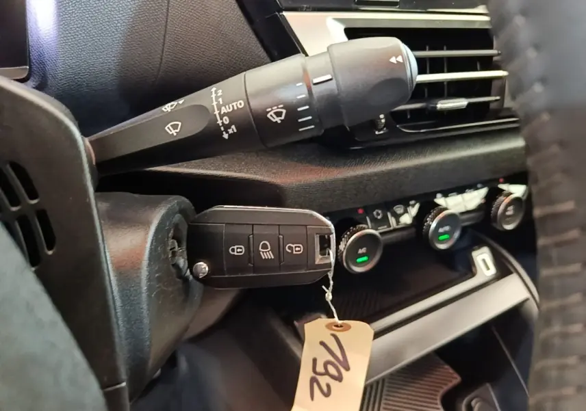 Gros plan sur la commande des essuie-glaces et le tableau de bord noir intérieur d'une Citroën C4 X 2023.
