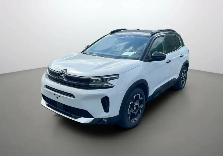 Citroën C5 Aircross Hybrid 2025 blanc okénite avec toit noir, vue 3/4 avant côté droit sur fond neutre.