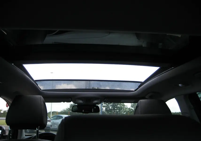 Vue intérieure arrière montrant le toit ouvrant panoramique du Hyundai Tucson noir fantom metal de 2016.