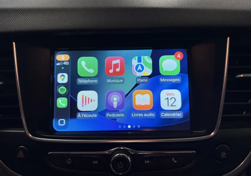 Écran tactile central de l’Opel Crossland 2023 affichant les applications Apple CarPlay dans un intérieur noir.