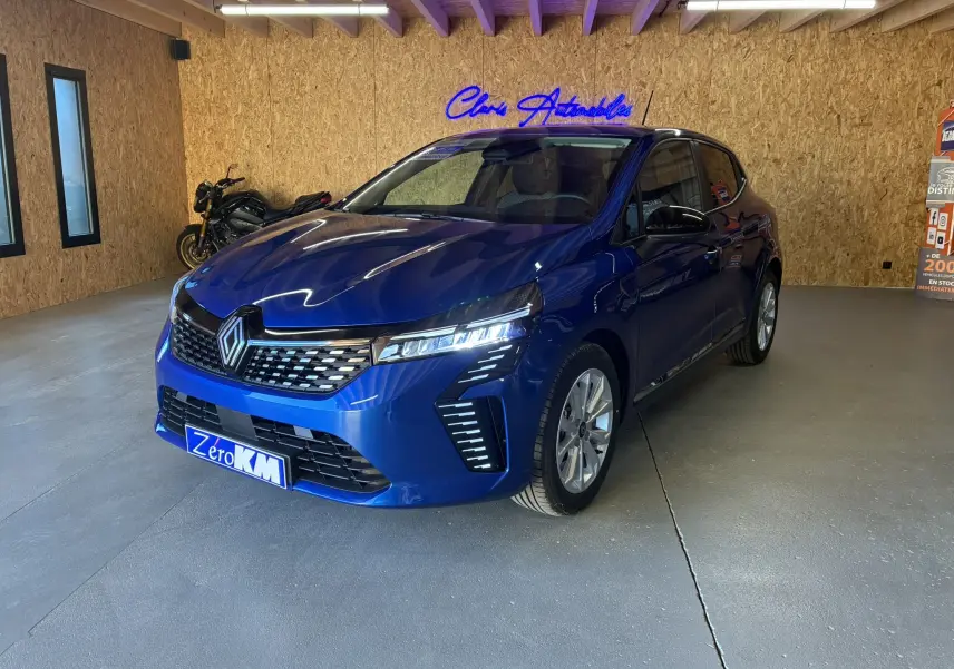 Renault Clio TCe 90ch X-Tronic Evolution bleu Iron vue 3/4 avant droit en intérieur avec éclairage LED distinctif.
