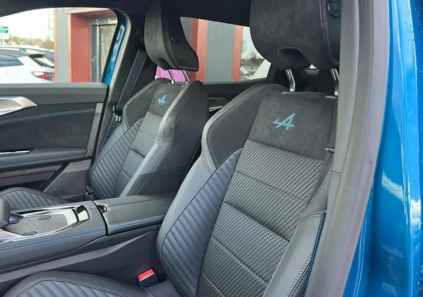 Vue intérieure côté droit des sièges avant en cuir et alcantara avec logo Alpine sur Renault Austral bleu outremer 2026.