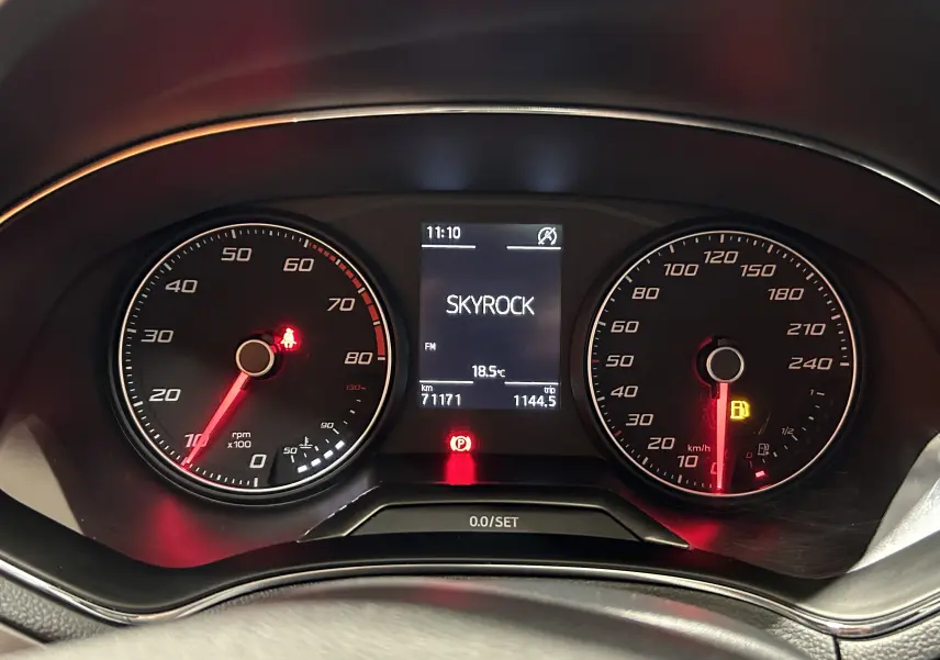 Vue rapprochée du tableau de bord de la SEAT Ibiza blanche 2019, affichant la radio Skyrock et les compteurs rpm et vitesse.