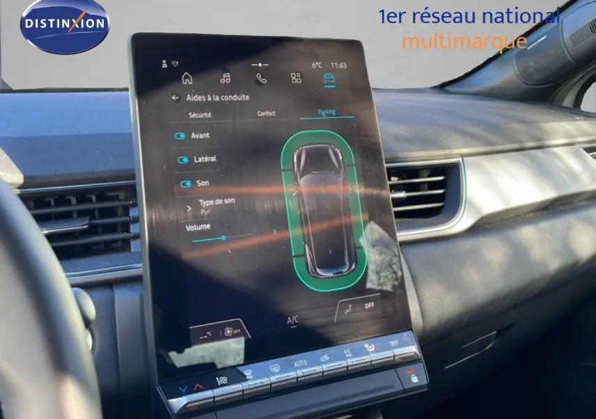 Vue intérieure centrée sur l'écran tactile du tableau de bord du Renault Captur 2025, ambiance grise et moderne.