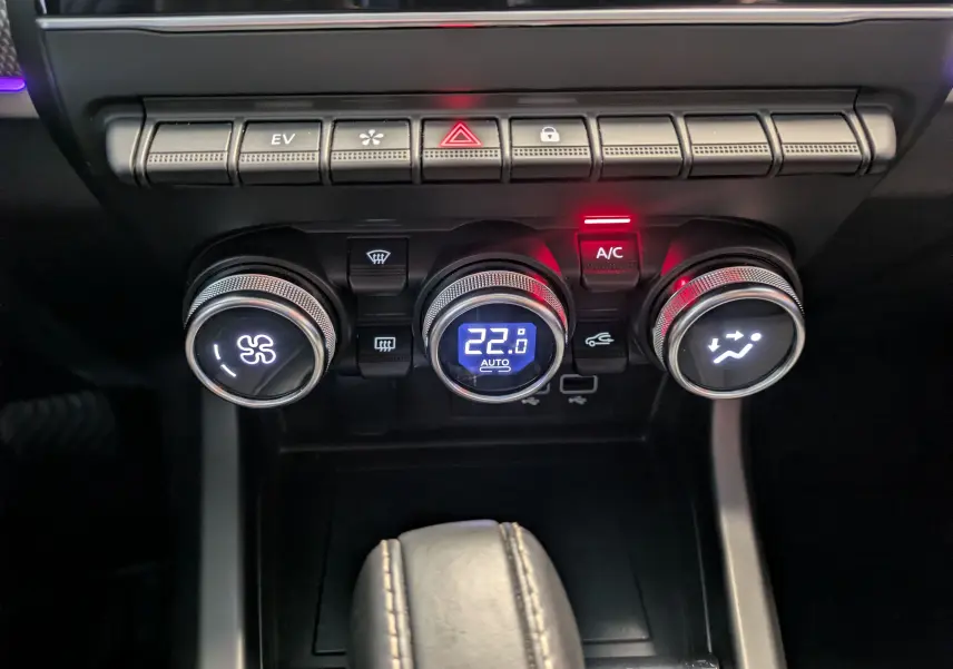 Vue rapprochée des commandes de climatisation et des boutons de fonction du tableau de bord du Renault Arkana 2023 noir métal.