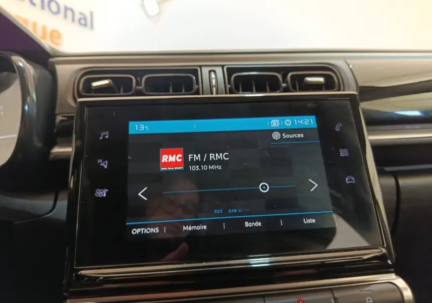 Écran tactile central de la Citroën C3 blanc 2022, vue rapprochée du système multimédia avec radio FM affichée.
