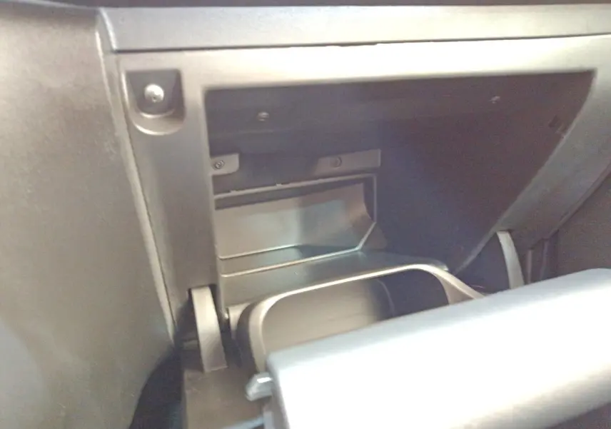 Gros plan sur la boîte à gants ouverte de la Citroën C3 blanche, intérieur noir mat, côté passager.