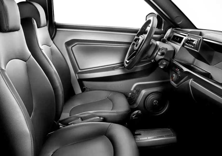 Vue intérieure côté conducteur de la LIGIER Myli 0.5 REVO D+ 2026, sièges confort noirs et tableau de bord minimaliste.